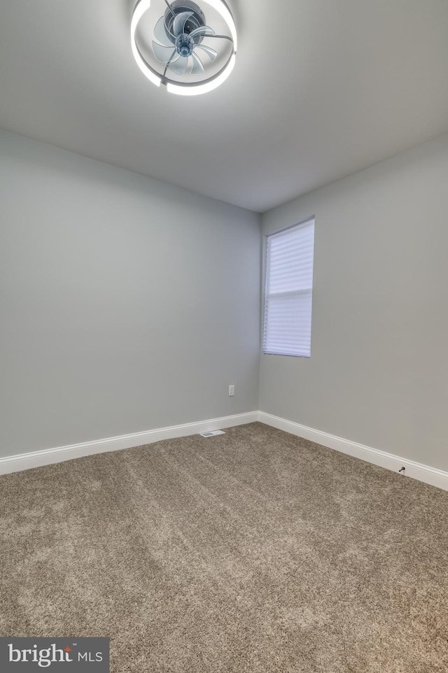 empty room with carpet flooring and ceiling fan