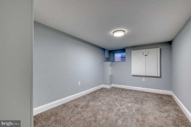 unfurnished room featuring light carpet