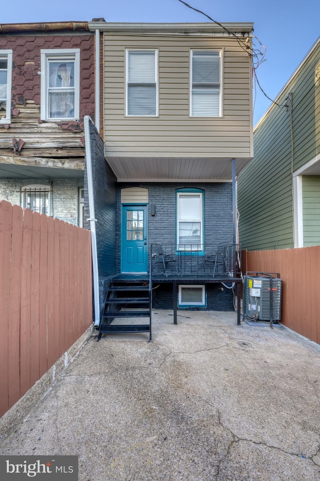 back of house featuring central air condition unit