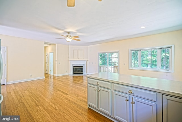 kitchen featuring light wood-type flooring, gray cabinets, and ceiling fan