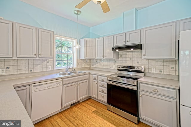 kitchen featuring white appliances, pendant lighting, light hardwood / wood-style floors, ceiling fan, and white cabinets