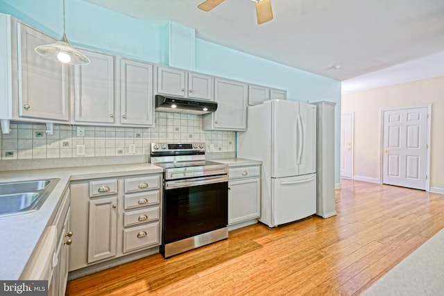 kitchen with light hardwood / wood-style flooring, stainless steel electric stove, ceiling fan, hanging light fixtures, and white refrigerator