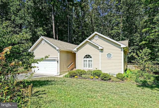 view of front of property with a front yard and a garage