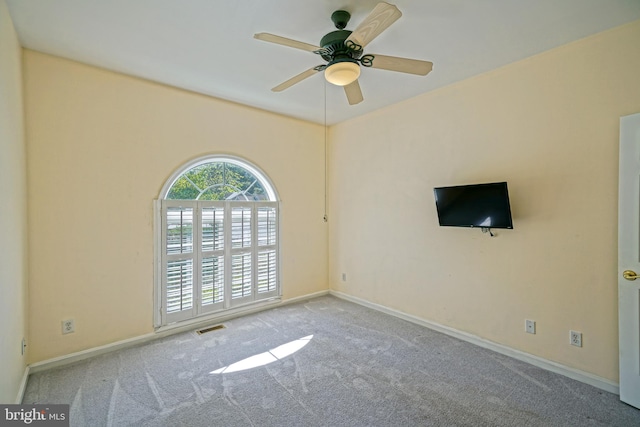 carpeted spare room with ceiling fan