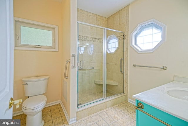 bathroom featuring vanity, toilet, a shower with shower door, and tile patterned flooring