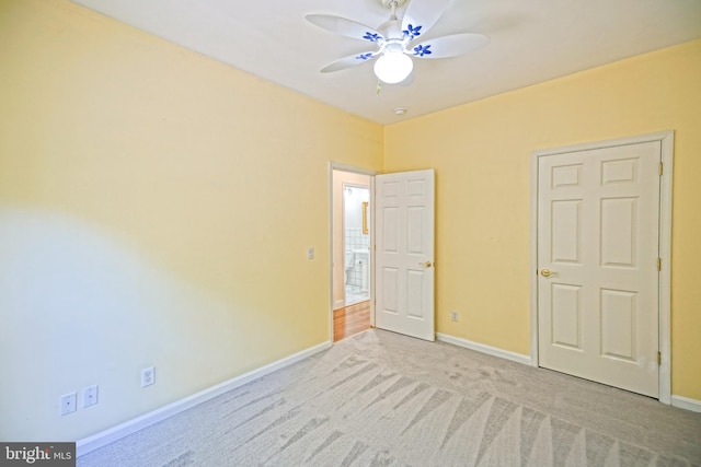 unfurnished bedroom with light carpet and ceiling fan