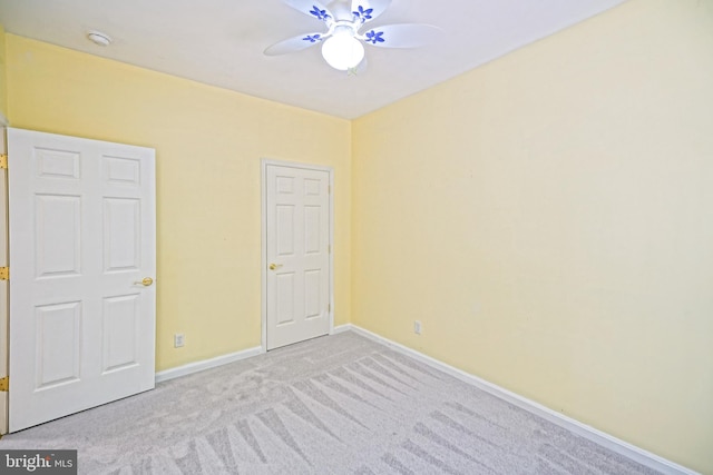 unfurnished bedroom with light colored carpet and ceiling fan