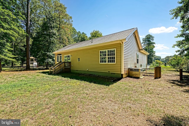 view of side of home featuring a lawn