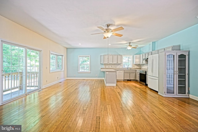 interior space featuring ceiling fan, sink, and light hardwood / wood-style flooring