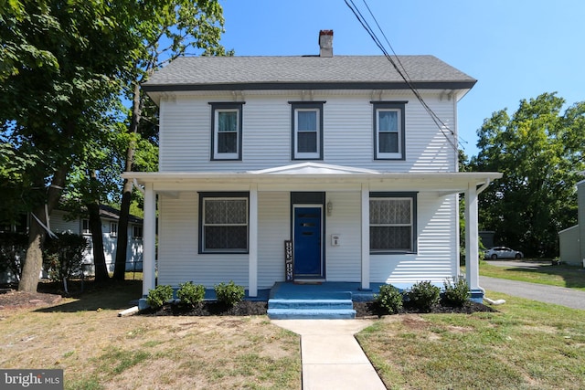 view of front of property featuring a porch and a front lawn