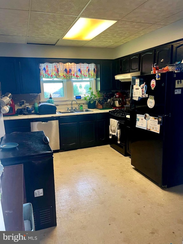 kitchen featuring black appliances, sink, and range hood