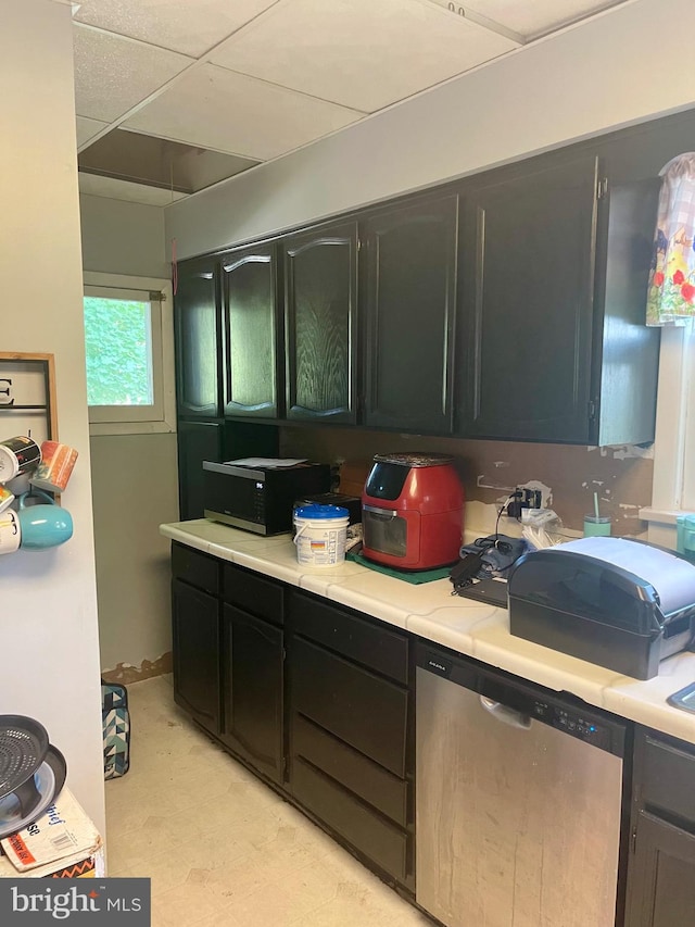 kitchen featuring dishwasher and a paneled ceiling