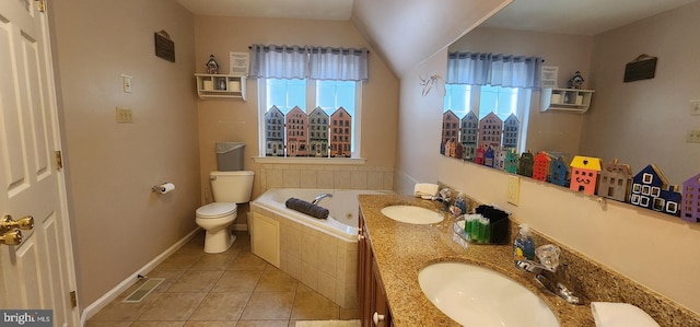 bathroom with plenty of natural light, toilet, vanity, and a relaxing tiled tub