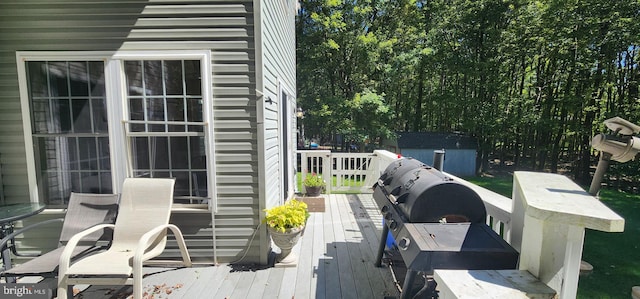 wooden terrace featuring a storage shed