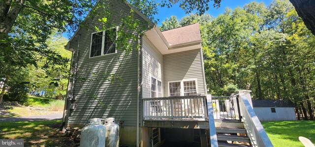 exterior space featuring an outbuilding and a wooden deck