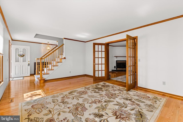 interior space featuring crown molding, hardwood / wood-style floors, and a notable chandelier