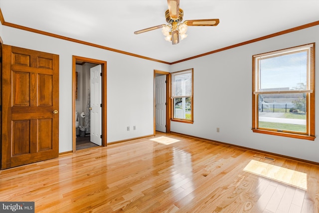 spare room with light wood-type flooring, ceiling fan, and crown molding