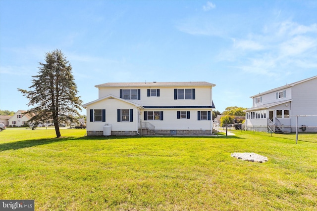 back of house featuring a yard