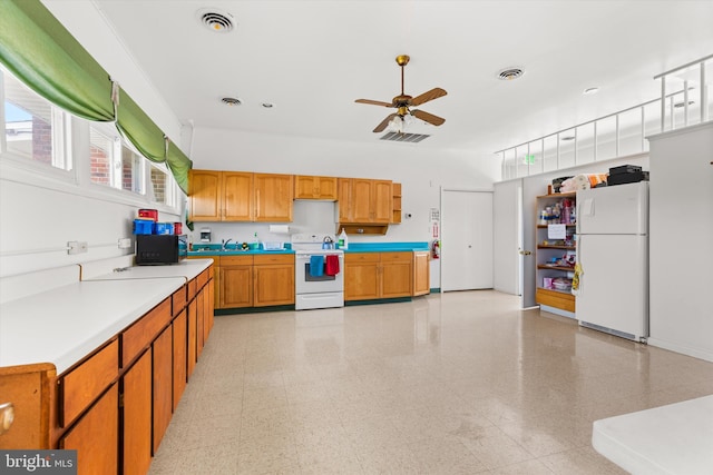 kitchen featuring ceiling fan, sink, and white appliances