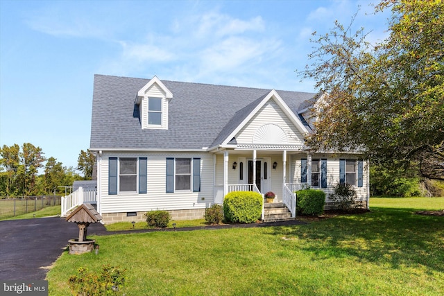 new england style home with covered porch and a front yard