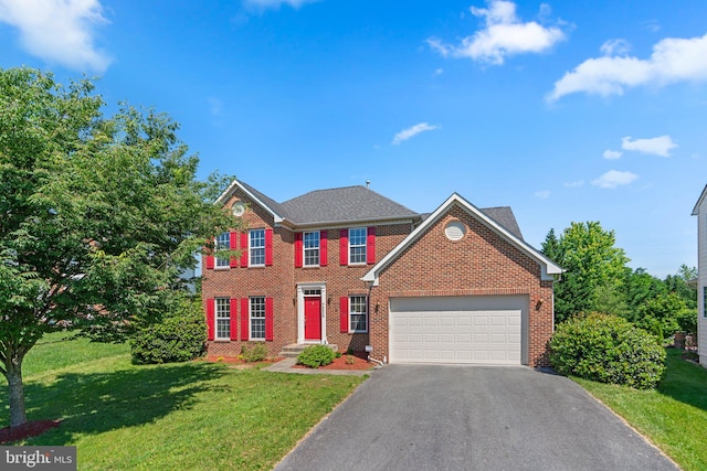 view of front of property with a garage and a front yard