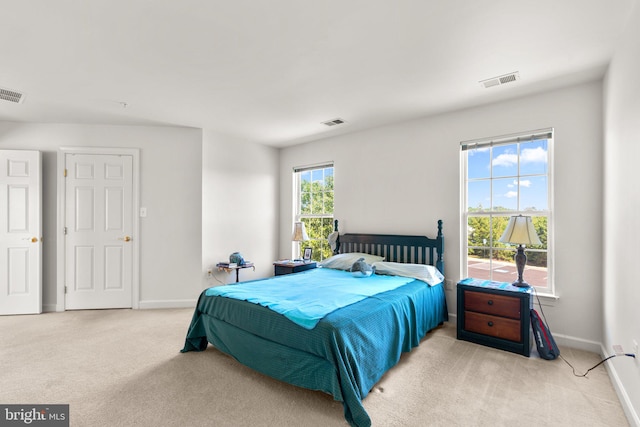 bedroom featuring light carpet