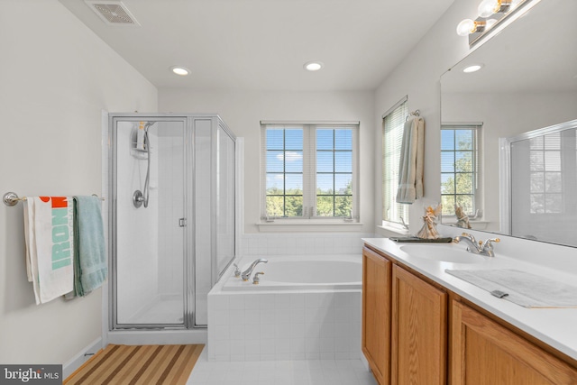 bathroom featuring vanity, independent shower and bath, and tile patterned floors