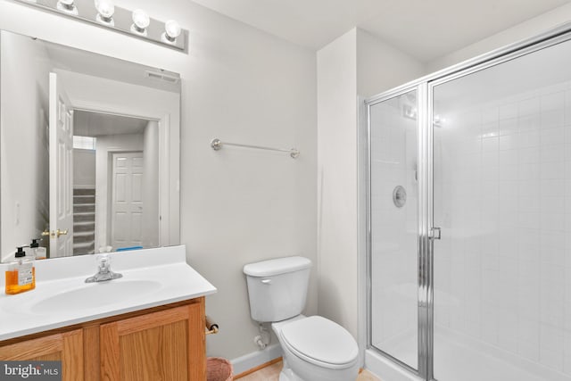 bathroom featuring vanity, toilet, and an enclosed shower