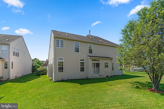 back of property featuring a yard