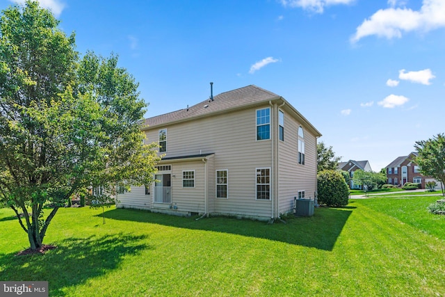 rear view of property with a yard