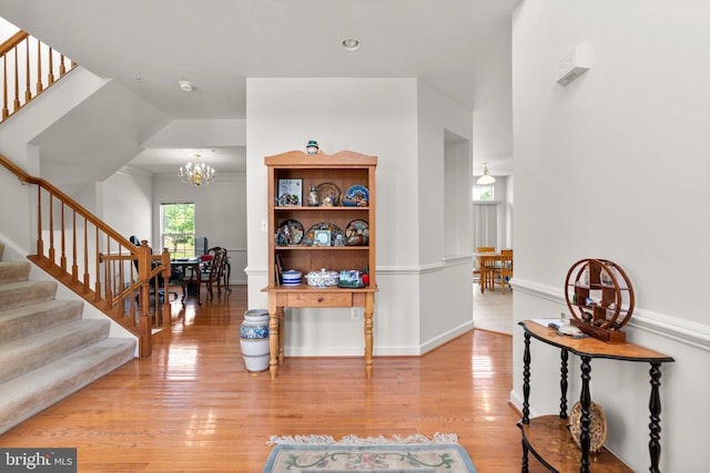 interior space featuring light hardwood / wood-style flooring and an inviting chandelier