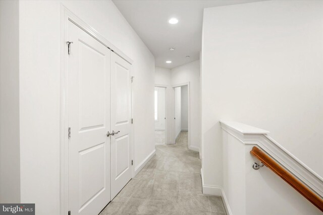 hallway with recessed lighting, baseboards, and light colored carpet