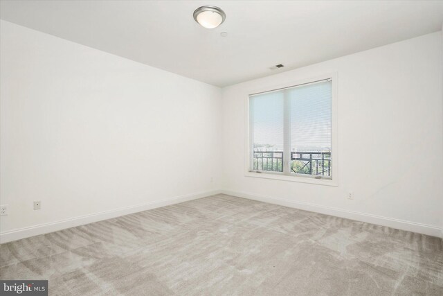 unfurnished room featuring visible vents, carpet flooring, and baseboards