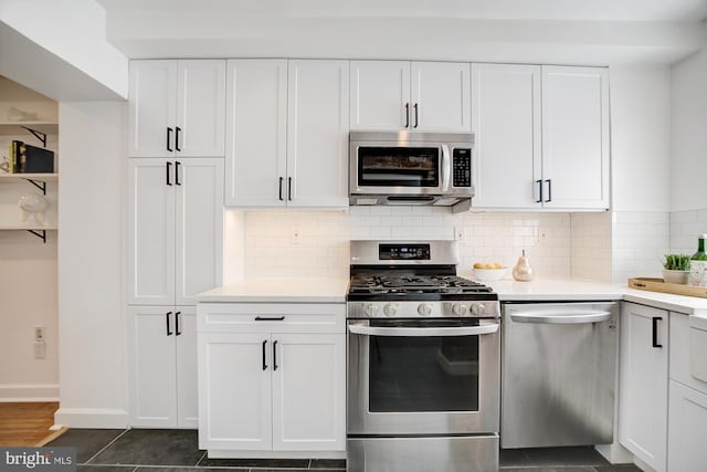 kitchen featuring stainless steel appliances, backsplash, and white cabinetry