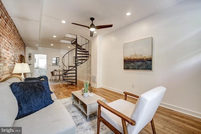 living room with ceiling fan and light hardwood / wood-style floors