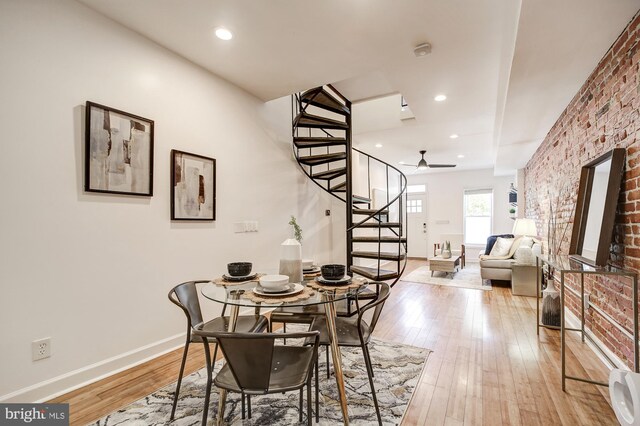 dining room with light hardwood / wood-style floors and ceiling fan