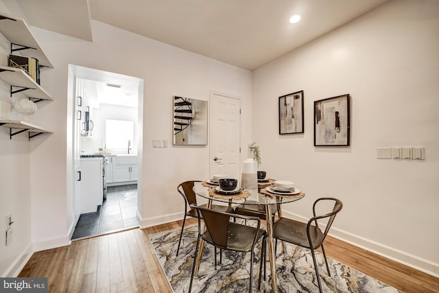 dining room with dark hardwood / wood-style flooring