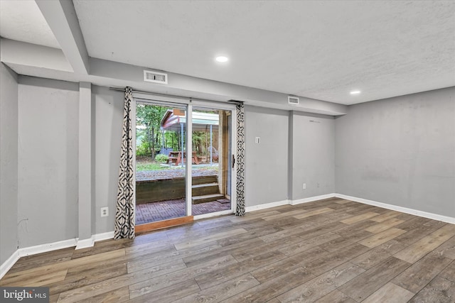 spare room featuring hardwood / wood-style floors