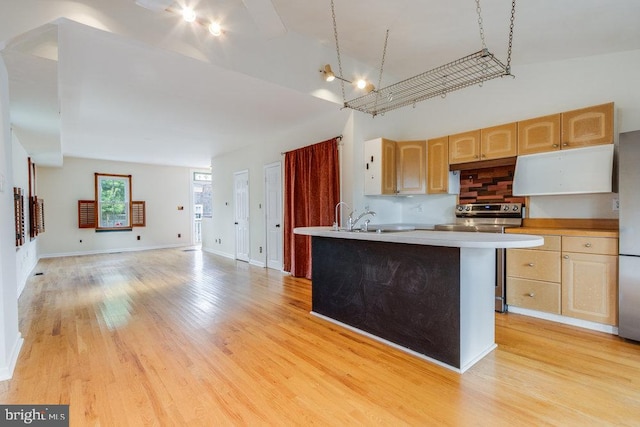 kitchen featuring a center island with sink, light hardwood / wood-style floors, light brown cabinetry, and stainless steel appliances