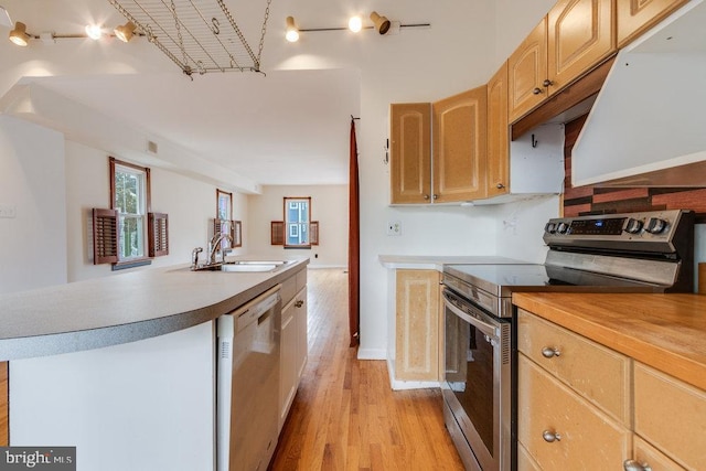 kitchen featuring light wood-type flooring, sink, light brown cabinets, stainless steel electric stove, and white dishwasher