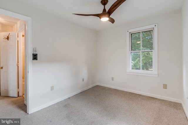 carpeted spare room with ceiling fan