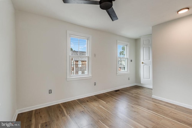 empty room with ceiling fan and light wood-type flooring