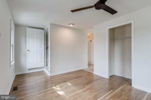 unfurnished bedroom featuring a closet, light wood-type flooring, and ceiling fan