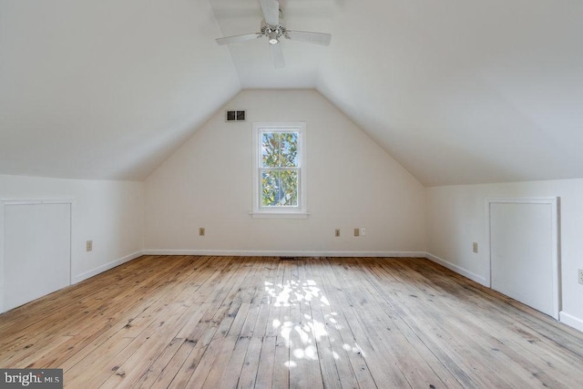 additional living space with ceiling fan, light hardwood / wood-style flooring, and vaulted ceiling