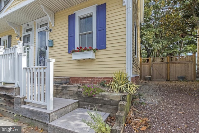 view of side of home featuring covered porch