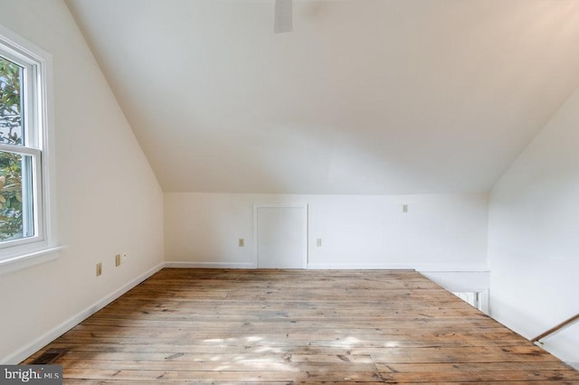 additional living space with lofted ceiling and light hardwood / wood-style floors