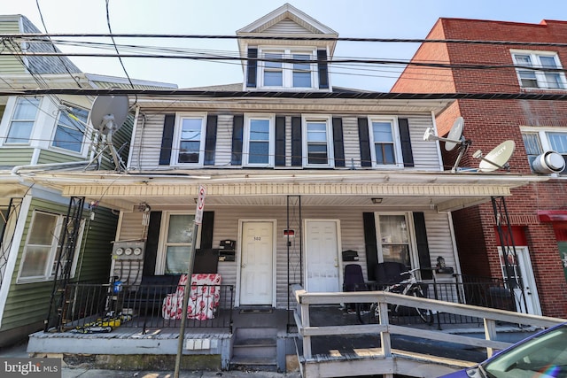 townhome / multi-family property featuring covered porch