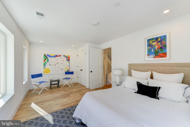 bedroom with hardwood / wood-style flooring