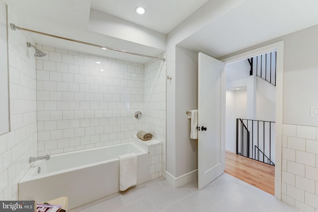 bathroom with tile patterned flooring and tiled shower / bath combo