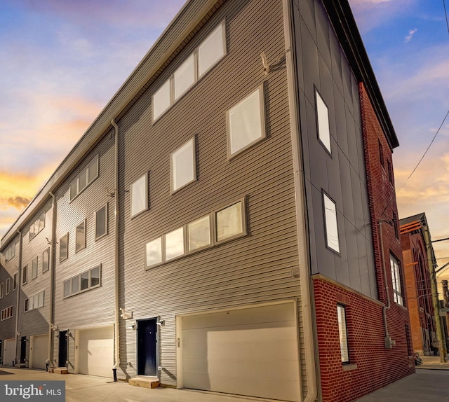 outdoor building at dusk featuring a garage